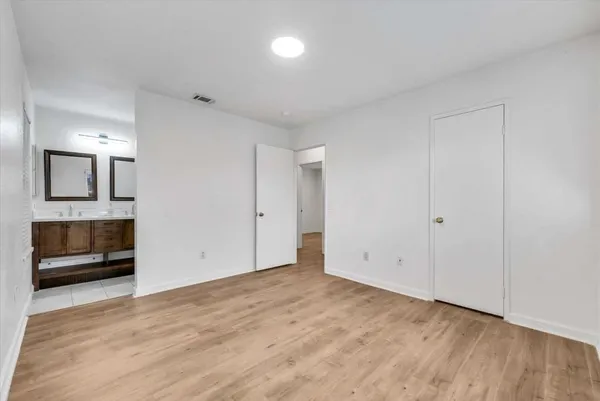 an empty room with a mirror and a bathroom