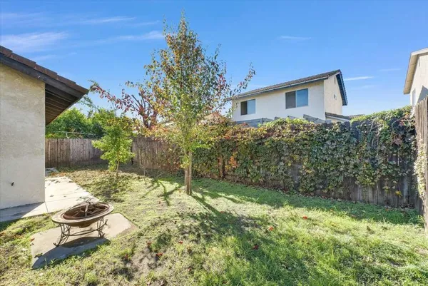 a backyard of a house with yard and outdoor seating