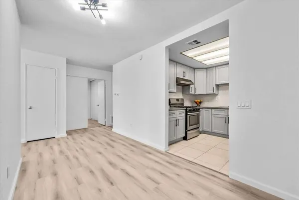 a kitchen with a refrigerator and a stove top oven
