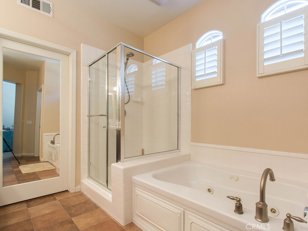 62 Shadowplay Irvine, CA 92620 - Photo 17 of 44 a bathroom with a tub and shower