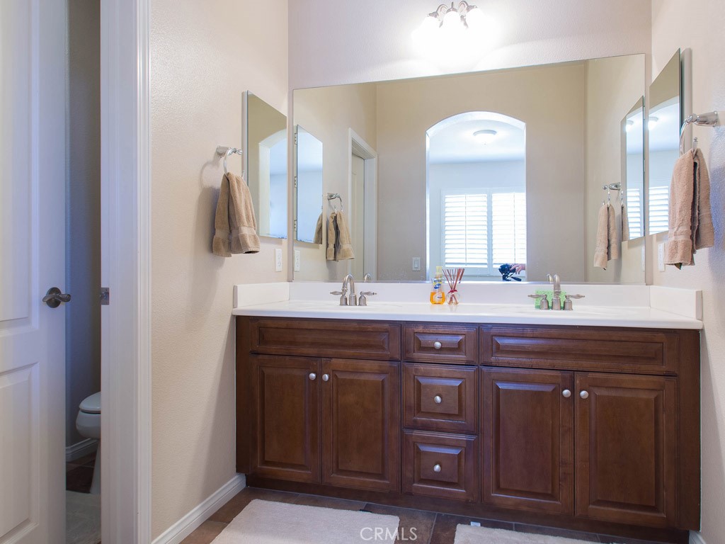 62 Shadowplay Irvine, CA 92620 - Photo 18 of 44 a bathroom with a double vanity sink and a mirror