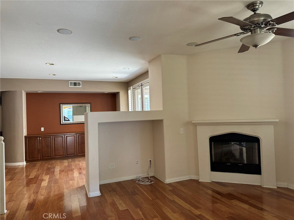 62 Shadowplay Irvine, CA 92620 - Photo 2 of 44 a view of empty room with a fireplace and wooden floor