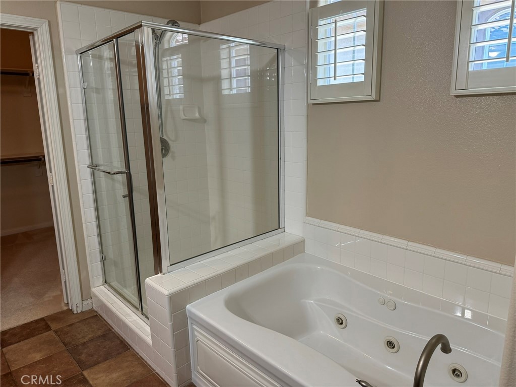 62 Shadowplay Irvine, CA 92620 - Photo 21 of 44 a bathroom with bathtub and shower