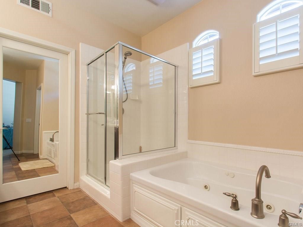 62 Shadowplay Irvine, CA 92620 - Photo 22 of 44 a bathroom with a tub and shower