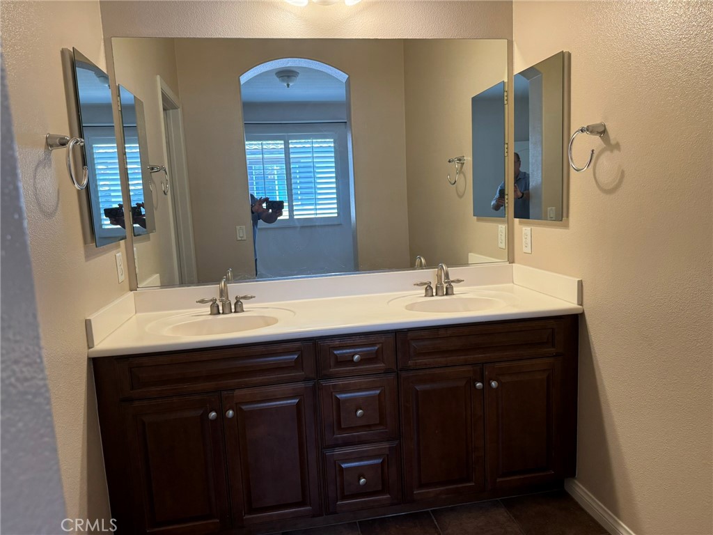 62 Shadowplay Irvine, CA 92620 - Photo 35 of 44 a bathroom with a double vanity sink and mirror