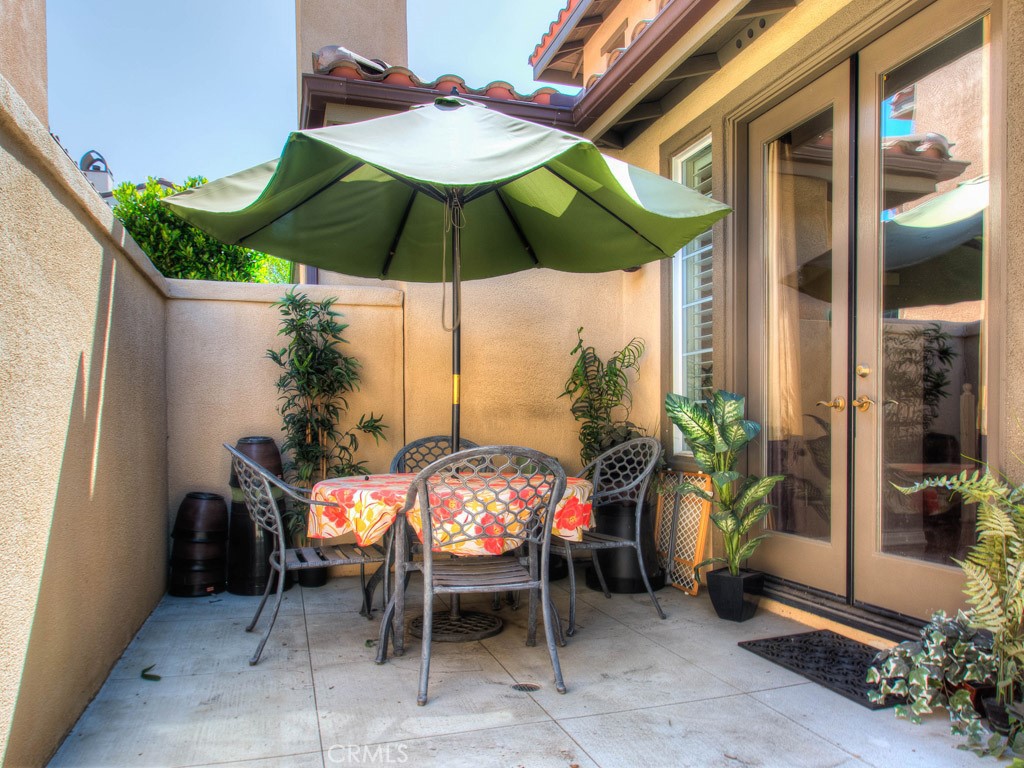 62 Shadowplay Irvine, CA 92620 - Photo 43 of 44 a patio with a table and chairs under an umbrella
