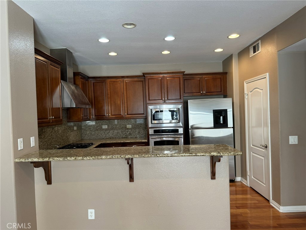 62 Shadowplay Irvine, CA 92620 - Photo 6 of 44 a kitchen with stainless steel appliances granite countertop a refrigerator and a sink