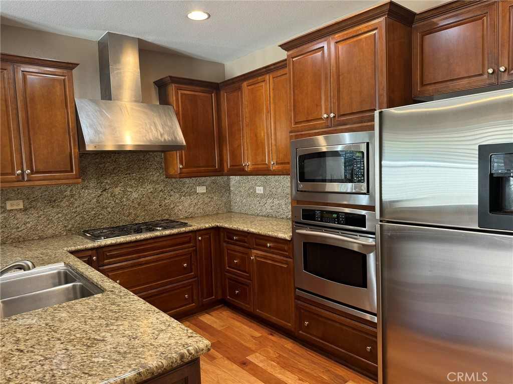 62 Shadowplay Irvine, CA 92620 - Photo 7 of 44 a kitchen with a sink stove and microwave