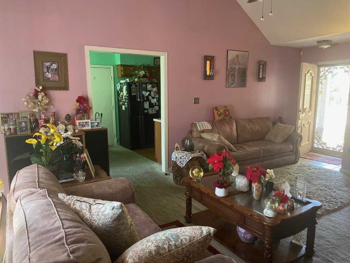 7665 Stone Manor Road Memphis, TN 38125 - Photo 2 of 9 a living room with furniture and flowers