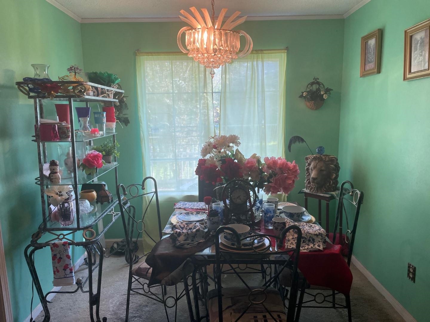 7665 Stone Manor Road Memphis, TN 38125 - Photo 4 of 9 a view of a dining room with furniture and a potted plant