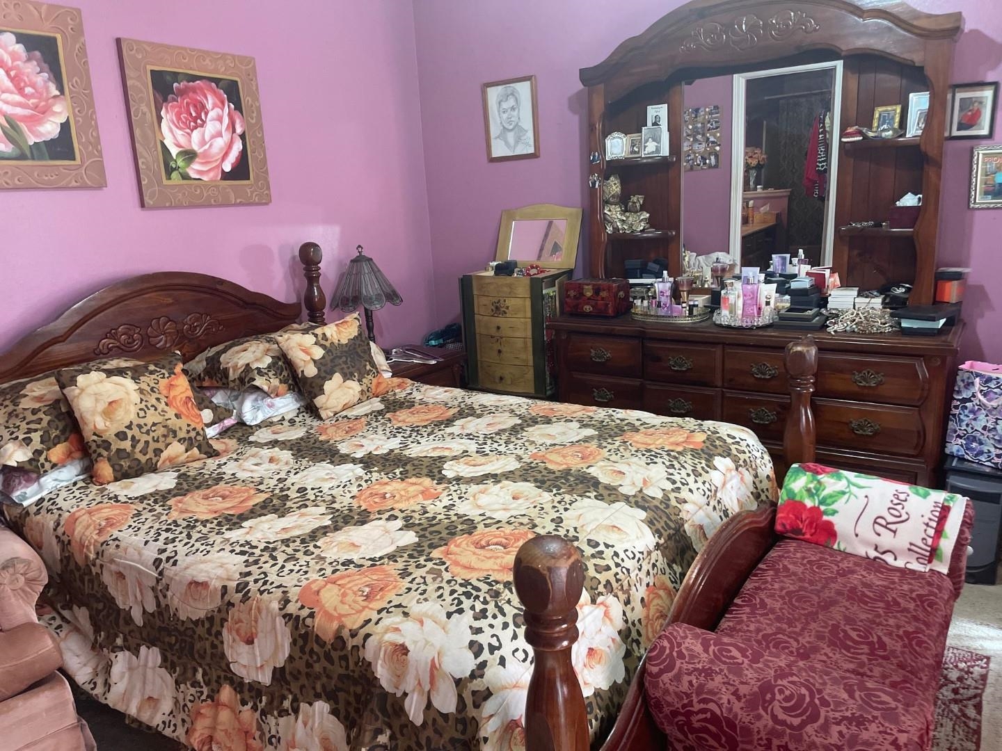 7665 Stone Manor Road Memphis, TN 38125 - Photo 6 of 9 a bed sitting in a bedroom and dresser with mirror