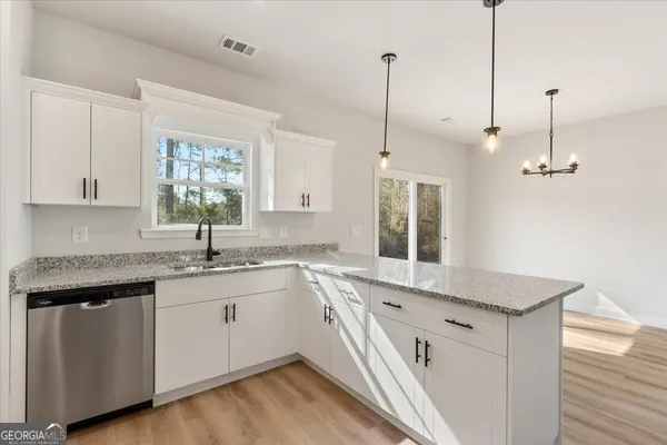 a kitchen with a sink stove and microwave