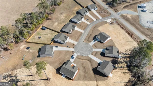 an aerial view of residential house with outdoor space and parking
