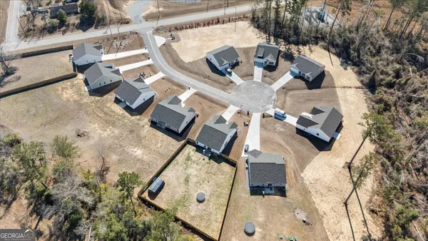 an aerial view of a house with a swimming pool