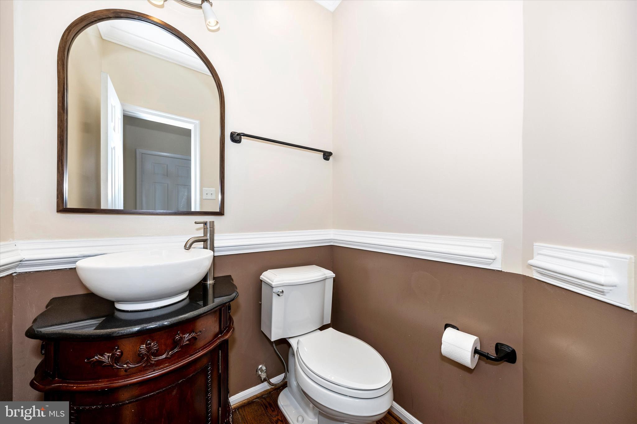 803 Apache Court Frederick, MD 21701 - Photo 16 of 46 a bathroom with a toilet a sink and mirror