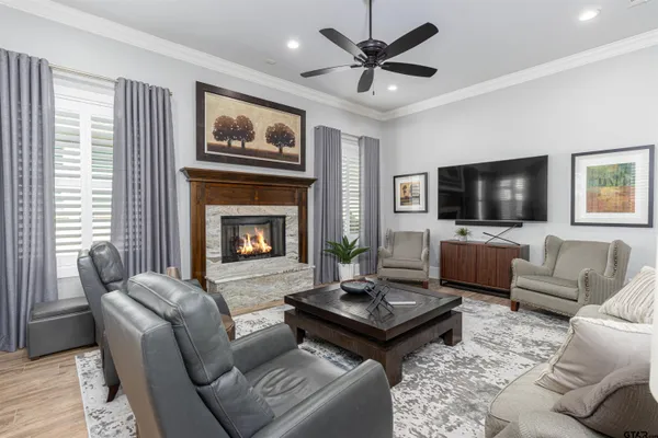 a kitchen with stainless steel appliances granite countertop a stove refrigerator and chairs