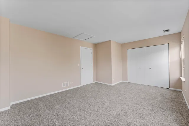a view of an empty room and closet area