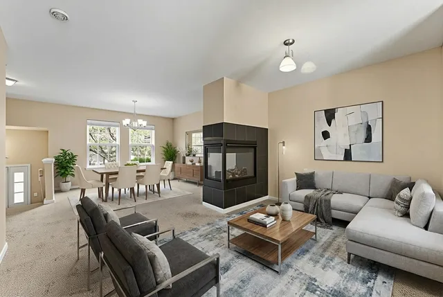 a living room with furniture fireplace and a window