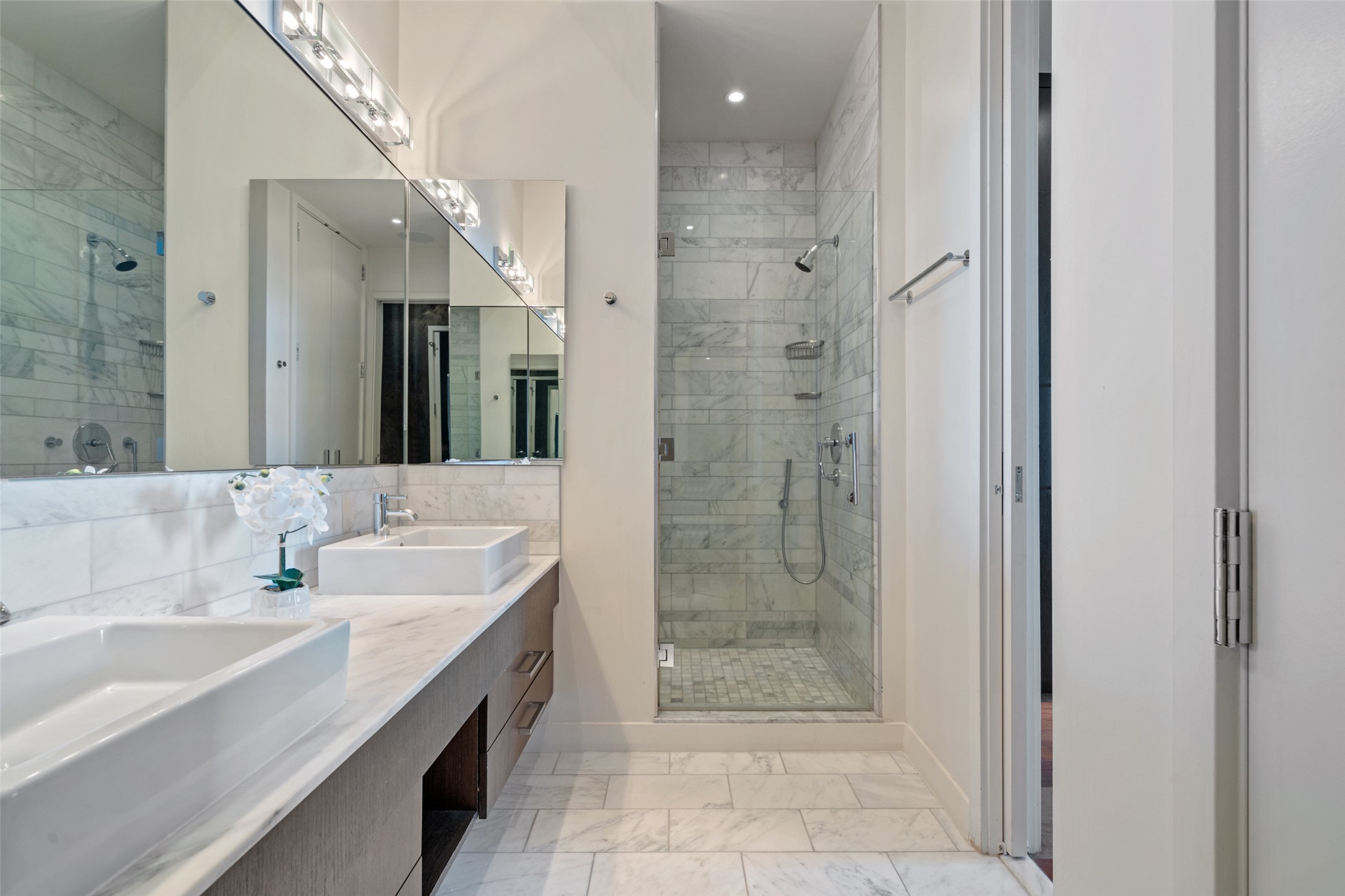 210 Lavaca Street, Unit 2203 Austin, TX 78701 - Photo 7 of 30 Full bath with a shower stall, double vanity, light marble finish flooring, and backsplash