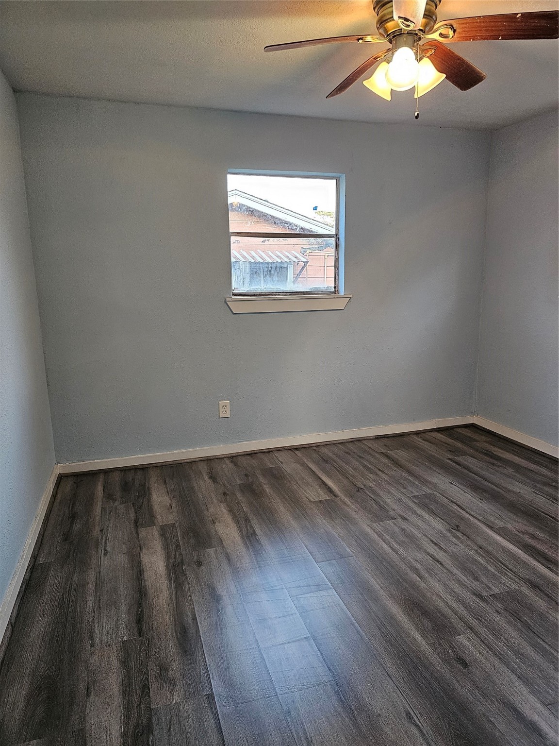 7808 Bauman Road Houston, TX 77022 - Photo 5 of 11 a view of a room with wooden floor and a ceiling fan