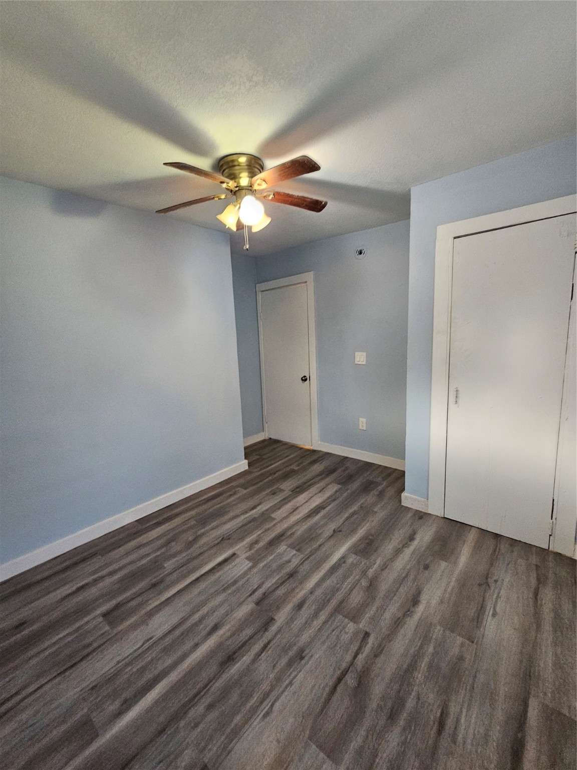 7808 Bauman Road Houston, TX 77022 - Photo 6 of 11 a view of empty room with wooden floor and fan