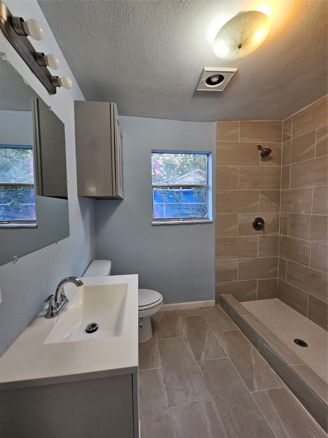 7808 Bauman Road Houston, TX 77022 - Photo 7 of 11 a bathroom with a sink a toilet and shower