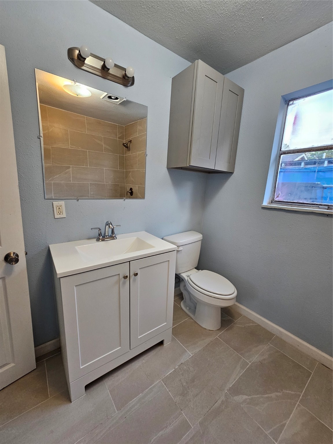 7808 Bauman Road Houston, TX 77022 - Photo 9 of 11 a bathroom with a toilet sink and mirror
