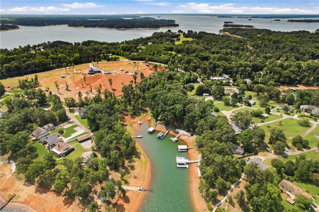 1110 Sunset Lane Anderson, SC 29626 - Photo 36 of 38 An aerial perspective reveals a serene waterfront community nestled among lush trees, with private docks extending into the clear lake.