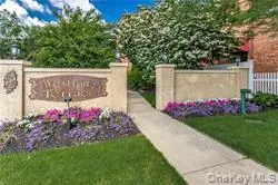 a view of a sign in front of flowers