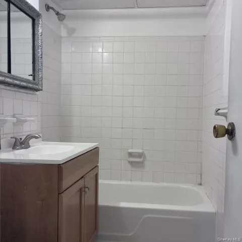 a white bath tub sitting next to a white sink