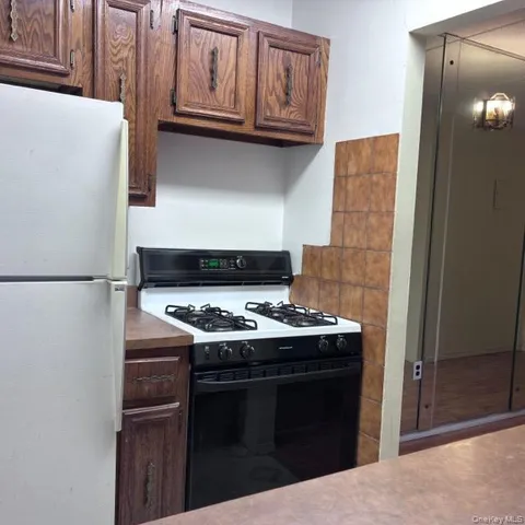 a stove top oven sitting inside of a kitchen