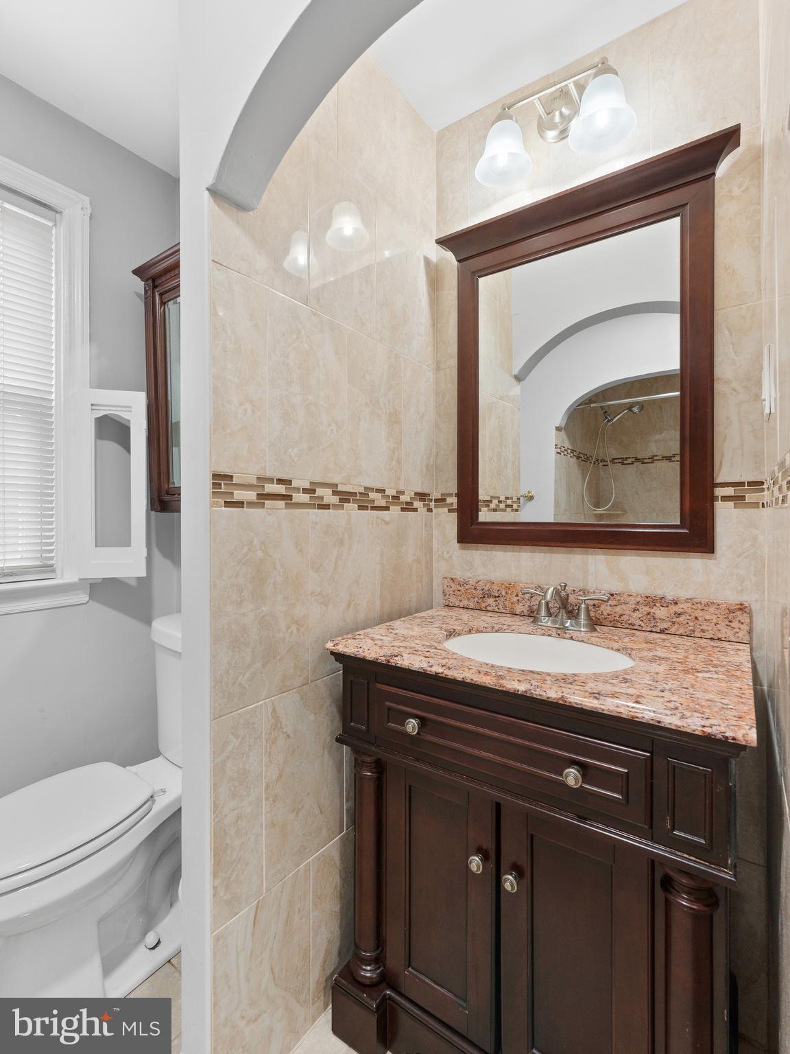 236 Boyer Road Cheltenham, PA 19012 - Photo 13 of 34 a bathroom with a granite countertop sink a toilet and a mirror