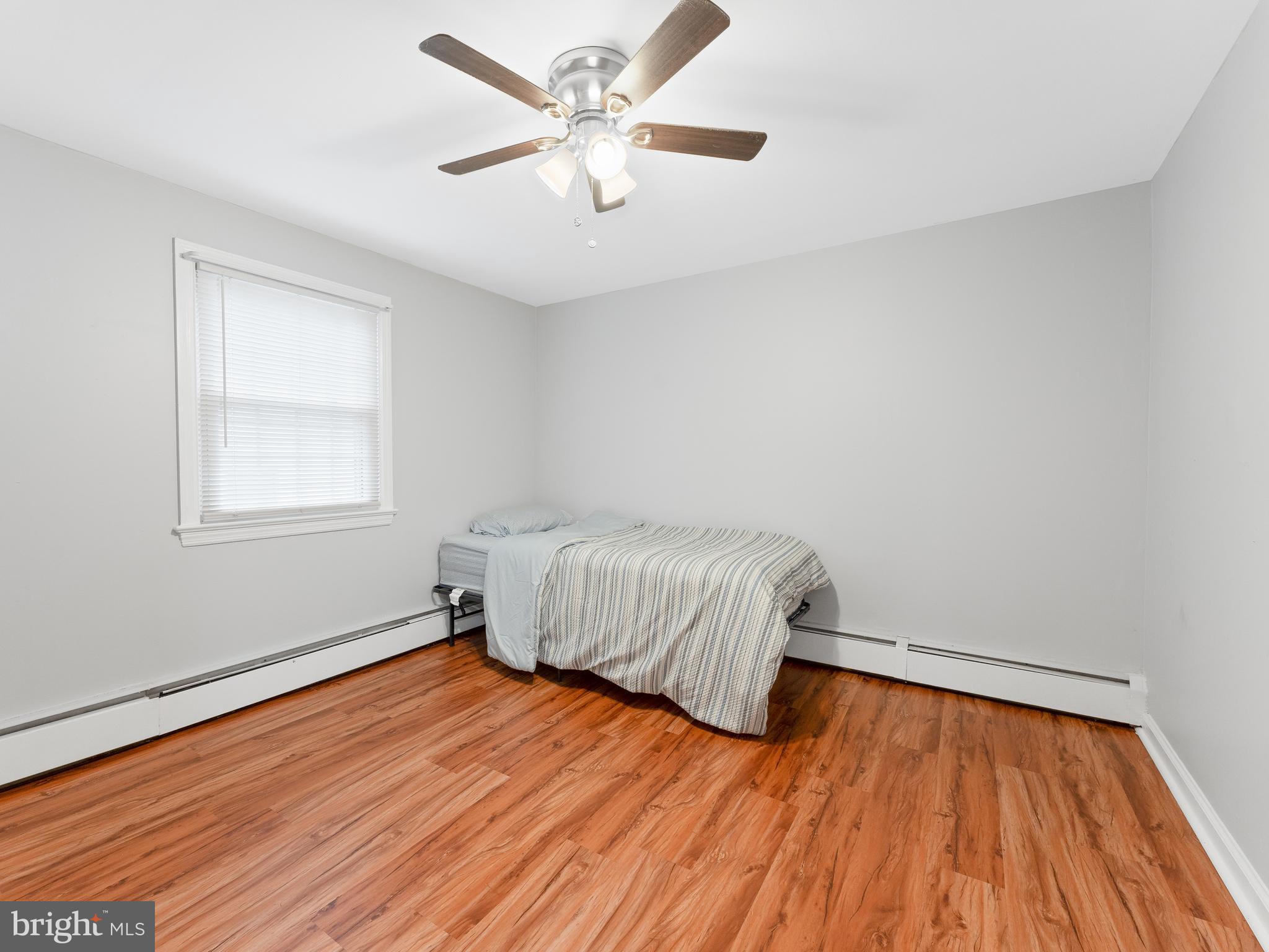 236 Boyer Road Cheltenham, PA 19012 - Photo 23 of 34 a bedroom with a bed and wooden floor