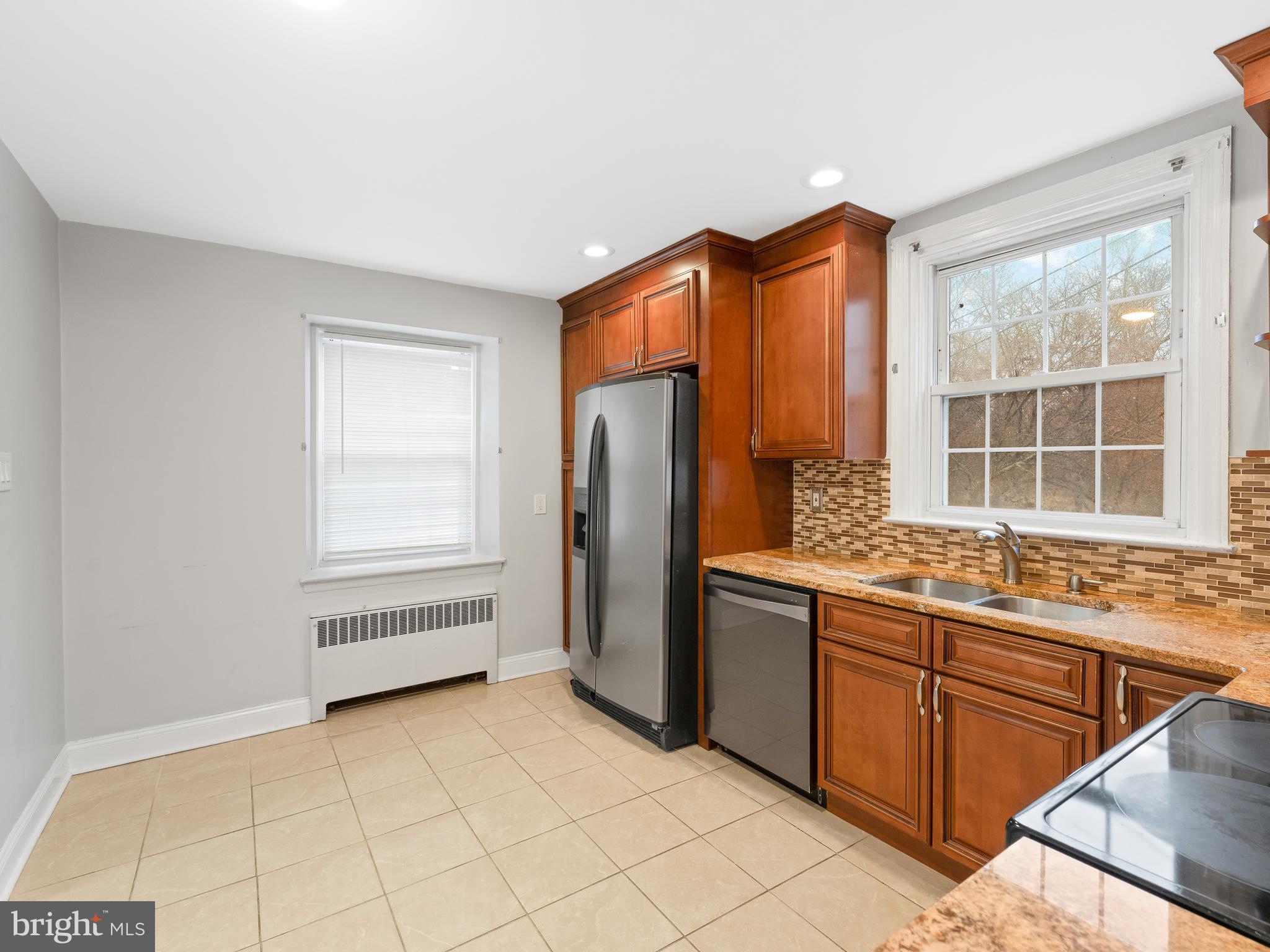 236 Boyer Road Cheltenham, PA 19012 - Photo 7 of 34 a kitchen with stainless steel appliances granite countertop a refrigerator and a stove top oven