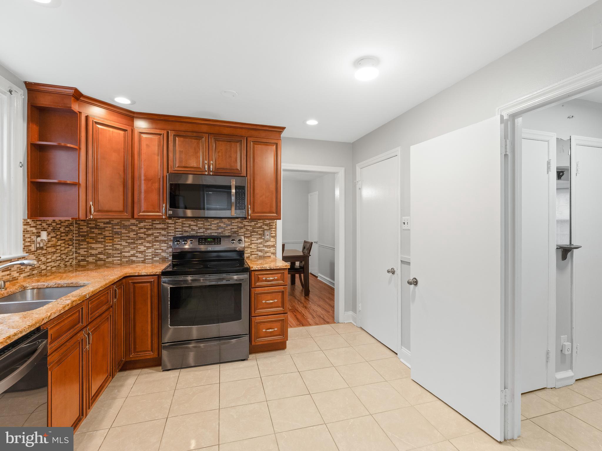 236 Boyer Road Cheltenham, PA 19012 - Photo 8 of 34 a kitchen with stainless steel appliances granite countertop a stove top oven a sink and dishwasher