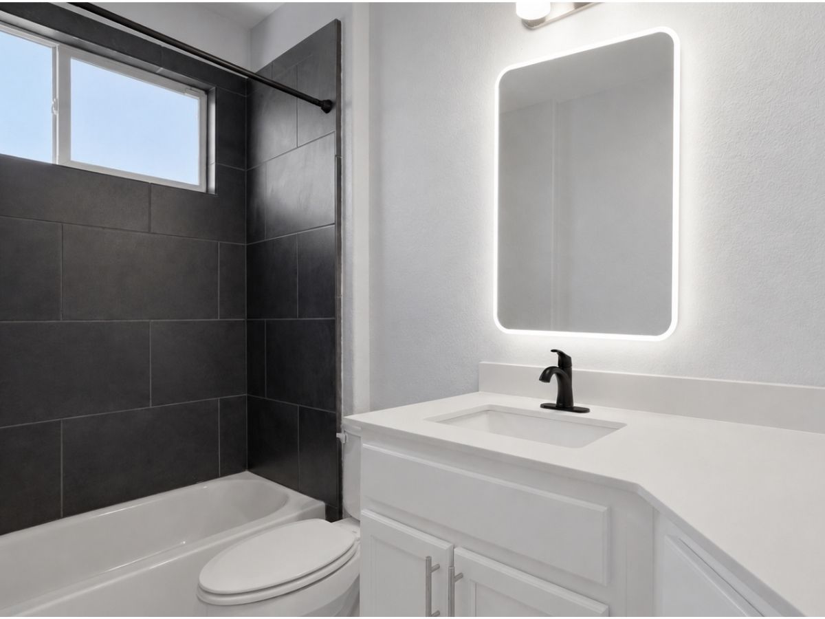 7208 Lysander Court Austin, TX 78741 - Photo 13 of 15 a bathroom with a sink toilet and shower