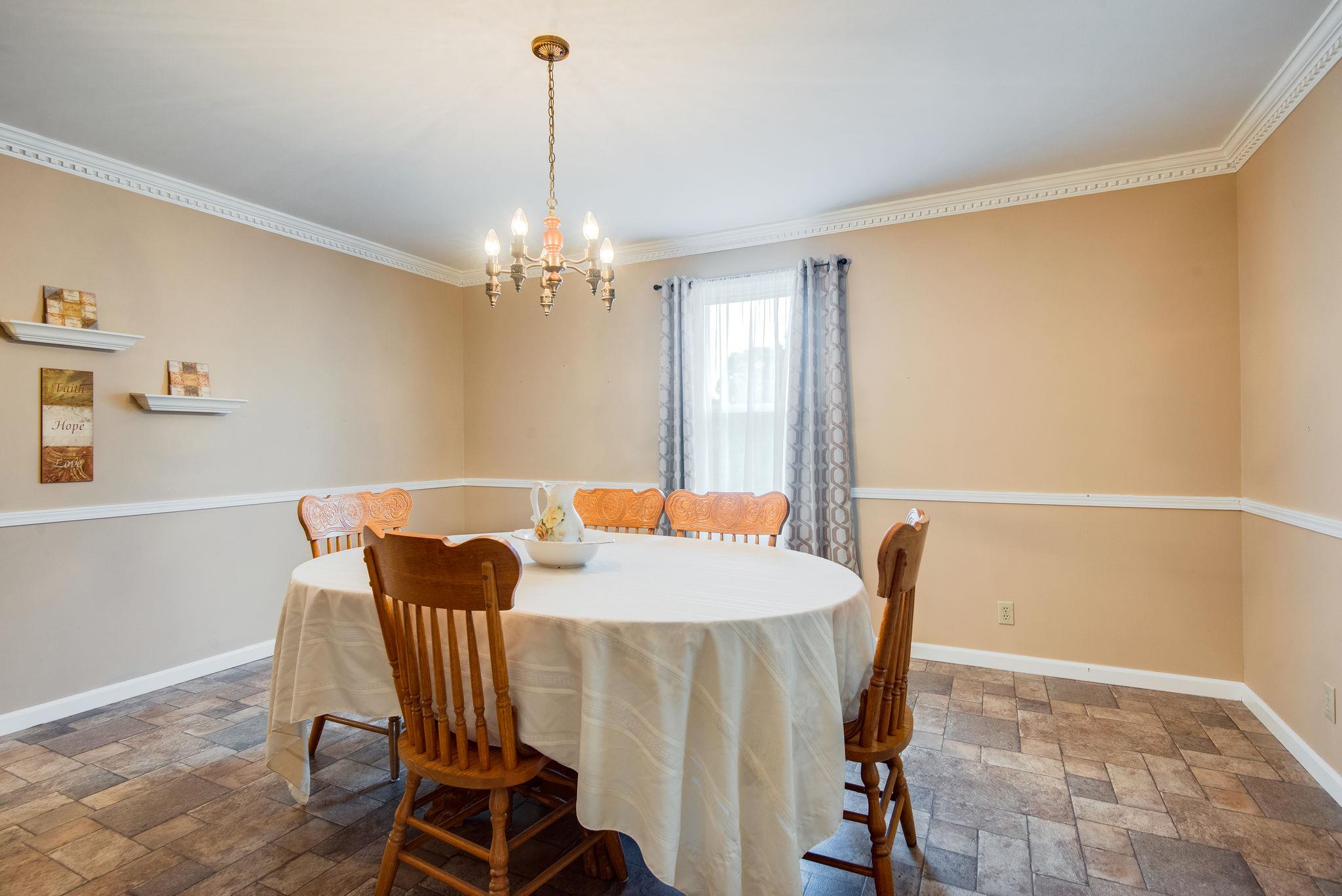 7357 Swift Road Greenbrier, TN 37073 - Photo 14 of 30 a view of a dining room with furniture window and wooden floor