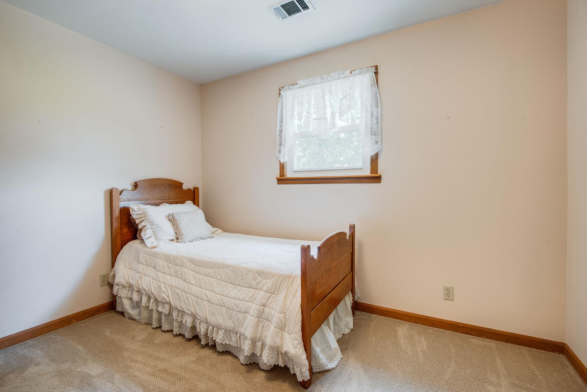 7357 Swift Road Greenbrier, TN 37073 - Photo 18 of 30 a bedroom with a bed and window