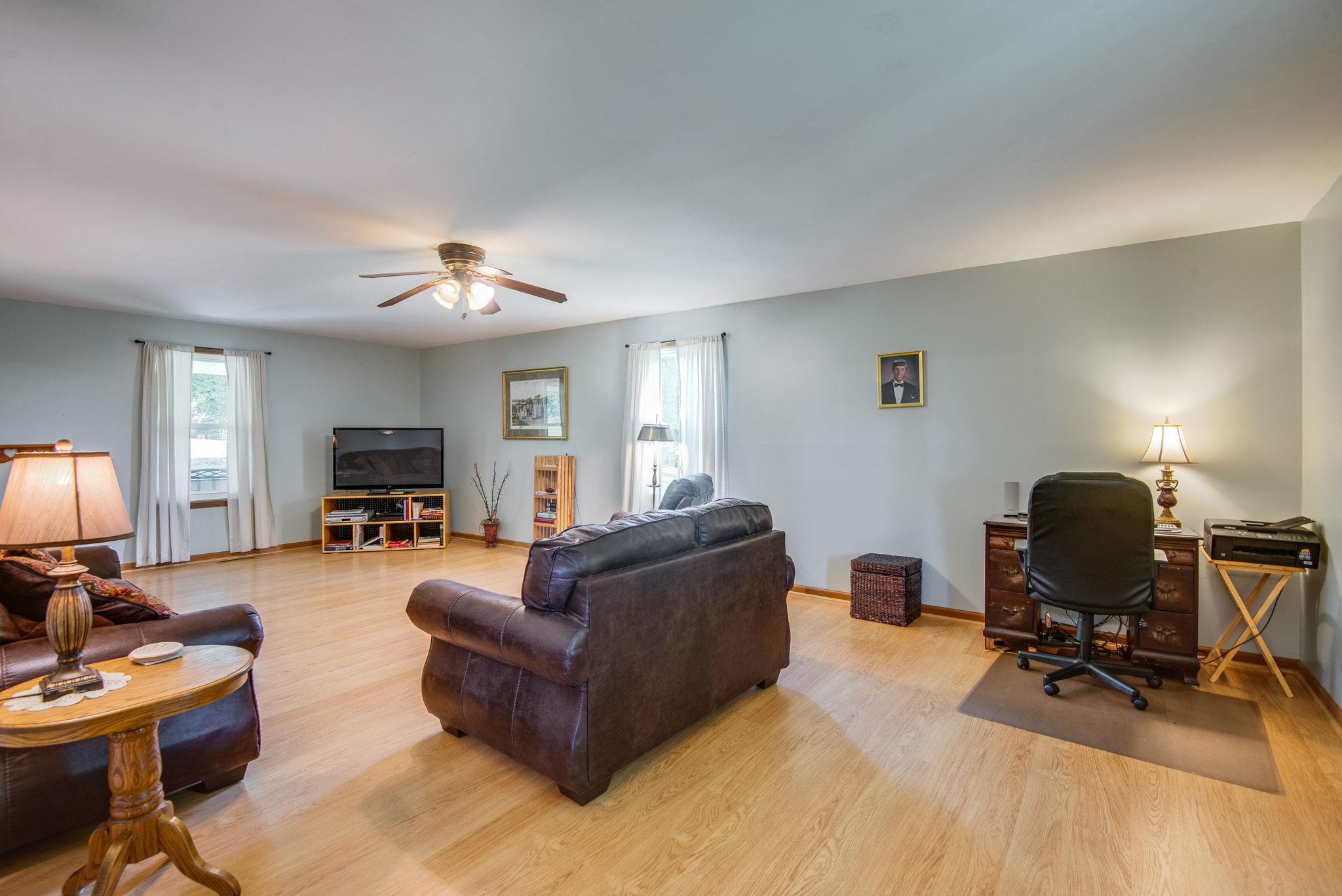 7357 Swift Road Greenbrier, TN 37073 - Photo 8 of 30 a living room with furniture a piano and a flat screen tv