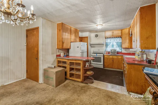 a room with furniture a window and stainless steel appliances