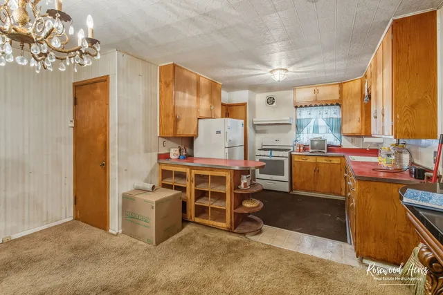 a room with furniture a window and stainless steel appliances