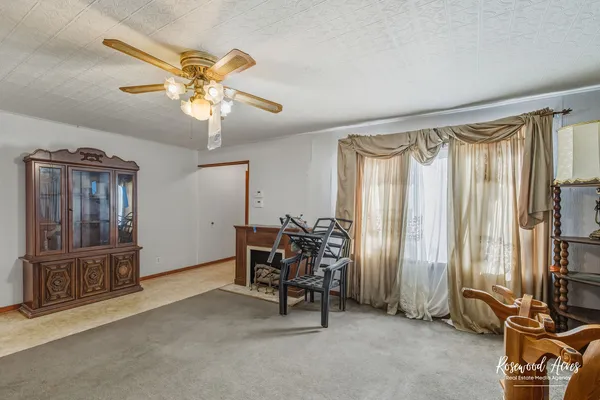 a view of a livingroom with furniture and a window