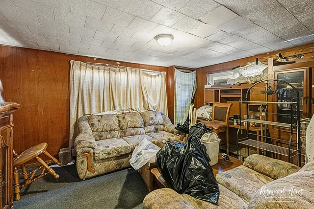 a living room with furniture a bike and a window