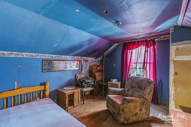 a living room with furniture fireplace and a window