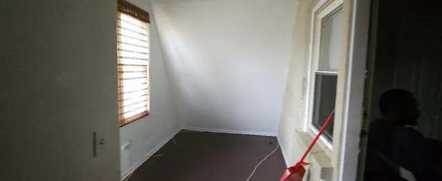 a view of an empty room and a window