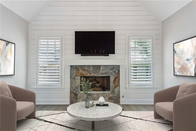 a dining room with wooden floor a chandelier fan a wooden table and chairs