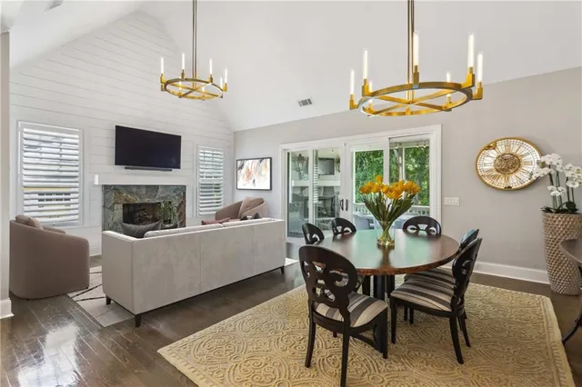 a living room with furniture a large window and a fireplace