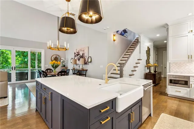 a living room with furniture a flat screen tv and a large window