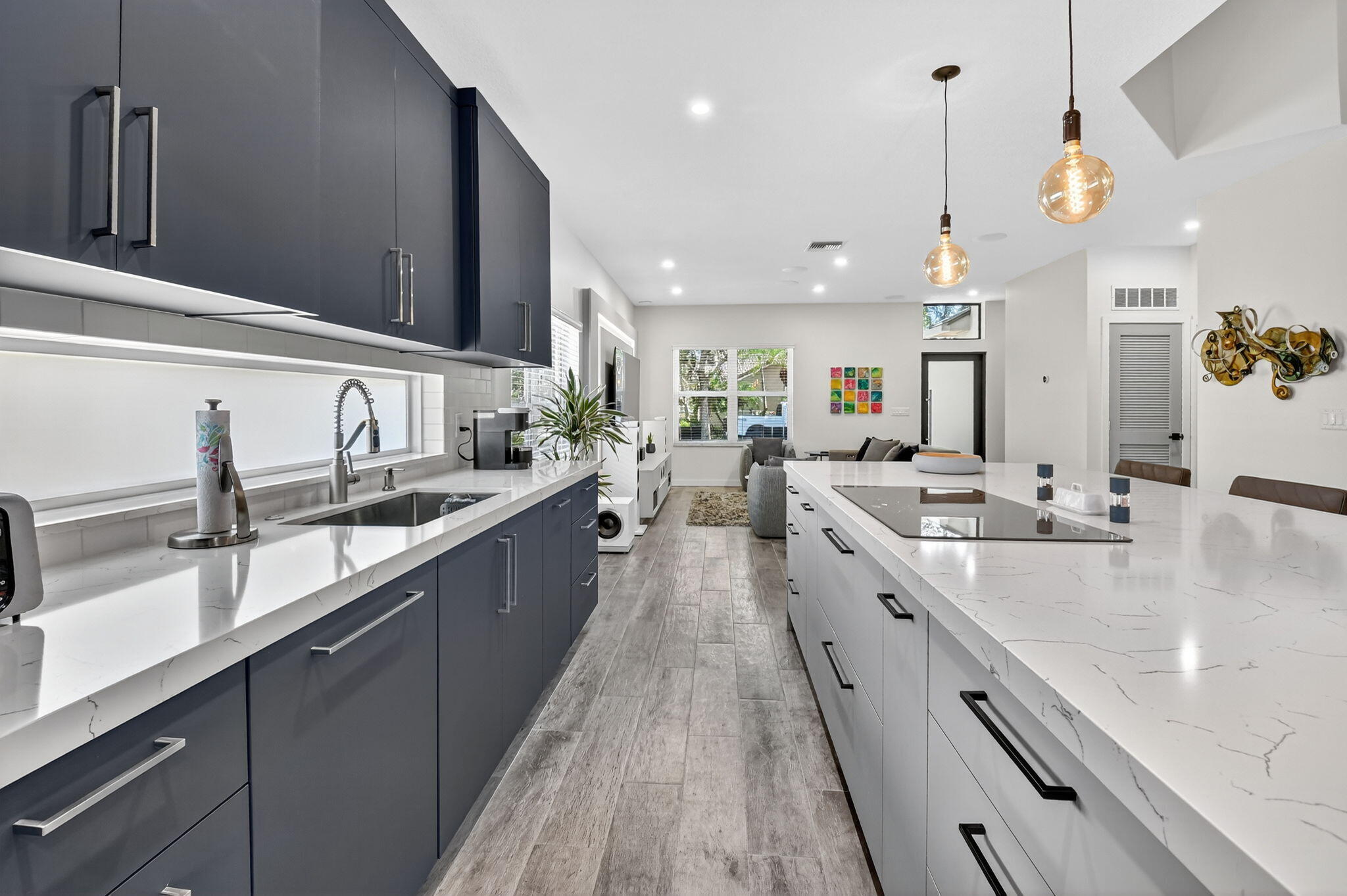 494 Enfield Court Delray Beach, FL 33444 - Photo 12 of 78 a large kitchen with stainless steel appliances kitchen island a large counter tops and a view of living room