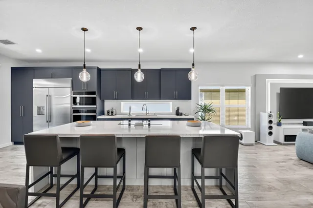 a kitchen with a center island appliances and cabinets